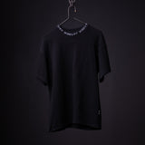 Black oversized cinch tee on hanger with decorative chain neckline detail, front view