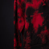 SM'22 Tie Dye Hoodie in red and black tie dye, worn on model showing front detail and pocket
