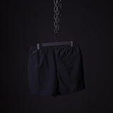 SP'22 Vintage 5" Training Short in black, hung on hanger against dark background