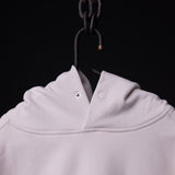 Tech Terry Eagle Hoodie in light pink, displayed on hanger showing hood and collar detail