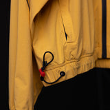 SM'24 Track Jacket in yellow, detail shot of drawstring and cuff with red toggle