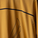SM'24 Track Jacket in gold, detail shot of fabric and line design