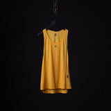 SM'24 Singlet Tank in gold yellow hanging on black hanger against dark background
