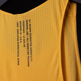 SM'24 Singlet Tank in gold yellow, detail closeup of perforated fabric and care instructions