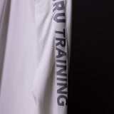 SP'20 Long Sleeve Shirt in white, sleeve detail closeup showing 'RUN TRAINING' text