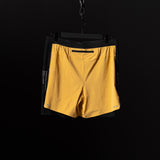 SM'24 4" Hybrid Liner Short in yellow, displayed on hanger against dark background