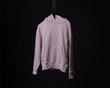 Light mauve Tech Terry Eagle Hoodie hanging on chain against black background