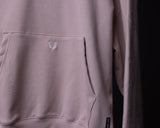 Tech Terry Eagle Hoodie in mauve being worn, detail shot of pocket and embroidered logo
