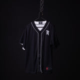 FA'21 Reversible Jersey in black with white piping on hanger against dark background