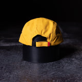 SM'24 5-Panel Run Cap in yellow and black, back view on dark surface