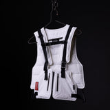 White technical vest with black straps and harness system displayed on hanger against black background