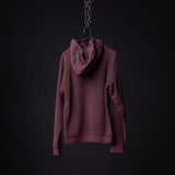 Burgundy reverse weave hoodie displayed on hanger against dark background, back view