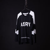 ASRY mesh long-sleeve jersey in black and white, displayed on hanger against dark background