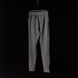 Garment Dyed Zip Jogger in gray, hanging on hanger against black background