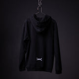 Black distressed hoodie on hanger against dark background, back view showing logo