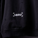 FA'20 Distressed Hoodie in black, close-up detail of ASRU logo embroidery on chest