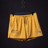 SM'24 Run Short in yellow, displayed on hanger against dark background