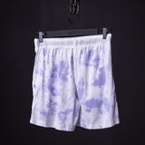 flatlay SM'22 Tie Dye Painted Short in purple and white, hung on black hanger against dark background