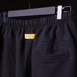 FA'23 Straight Leg Jogger in black, displayed on hanger with yellow Training Division label visible