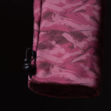 Brushed camo cargo jogger in burgundy, held against dark background detail shot