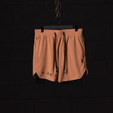 FA'22 7" Liner Short in peach, displayed on hanger against dark background