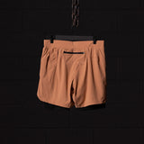 flatlay FA'22 7" Liner Short in tan/caramel, back view on hanger