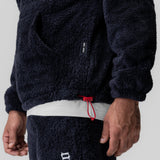 Sherpa Recovery Hoodie in navy worn by model, showing waistband detail with red drawstring
