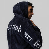 Navy Sherpa Recovery Hoodie with white text on back, worn by model in profile