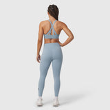 W002 LYCRA® ADAPTIV Legging in light sky, worn by model from behind showing strappy back detail