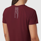 Crimson Laser-Vent Established Tee worn by model, back view showing white text graphic