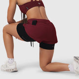 W025 Tetra-Lite Liner Short in crimson with black shorts, worn by model in kneeling pose