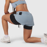 Tetra-Lite® Liner Short in light sky and black, worn by model kneeling on white background