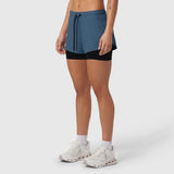Tetra-Lite Liner Short in storm blue and black, worn by model with white sneakers