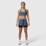 Tetra-Lite Liner Short in storm blue with black liner, worn with matching sports bra, front view