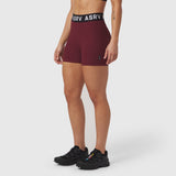 ASRV Lycra Ribbed Short in crimson, worn by model with black sneakers, front view