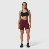 Crimson LYCRA® ADAPTIV biker shorts worn with black sports bra, front-facing pose