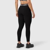 Black LYCRA® ribbed leggings worn by model, back view, with branded waistband