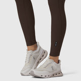 W071 LYCRA® Ribbed Legging in Dark Earth, worn with white sneakers, front view