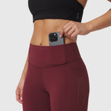 W072 LYCRA® ADAPTIV 4 Pocket Legging in crimson, model wearing legging with phone in pocket