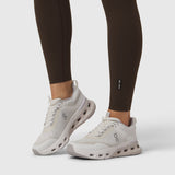 W072 LYCRA® ADAPTIV 4 Pocket Legging in Dark Earth, worn with white sneakers, front view