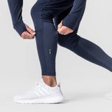 Thermal Hybrid Jogger in navy worn by model with white sneakers, leg detail