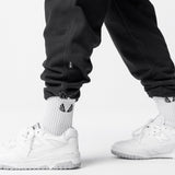 Black Tech-Terry Cinch Cargo Jogger worn with white socks and sneakers, styled shot