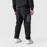 Black Tech-Terry Cinch Cargo Jogger worn by model, back view with white sneakers