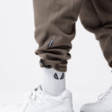 Tech-Terry Cinch Cargo Jogger in deep taupe, worn with white socks and sneakers, lower body view