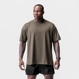 Core Mesh Oversized Tee in deep taupe worn by model with black shorts, front view