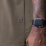 Core Mesh Oversized Tee in Deep Taupe worn by model with smartwatch, side view