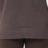 Distressed Relaxed Tee in Dark Earth worn by model, front view showing chest logo