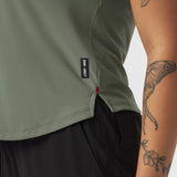 Laser-Vent Established Tee in sage worn by model, side detail view showing ventilation holes