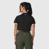 Black AeroSilver cropped tee worn by model, back view, paired with olive cargo pants