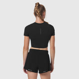 Black LYCRA® cropped tee worn by model, back view, paired with black shorts